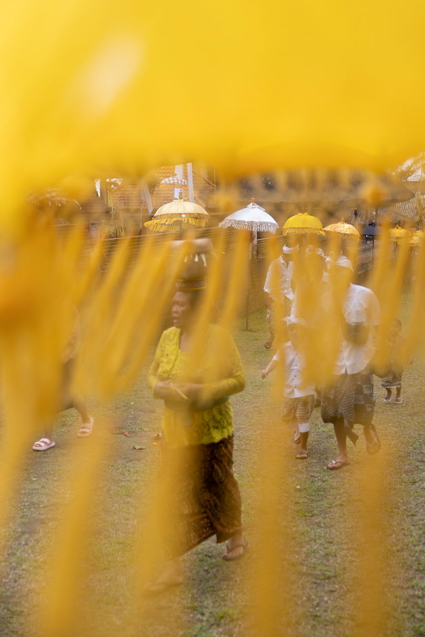 A procession seen through streaming yellow glass.