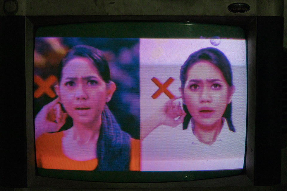 A television drama, a woman's face beside a red cross graphic.