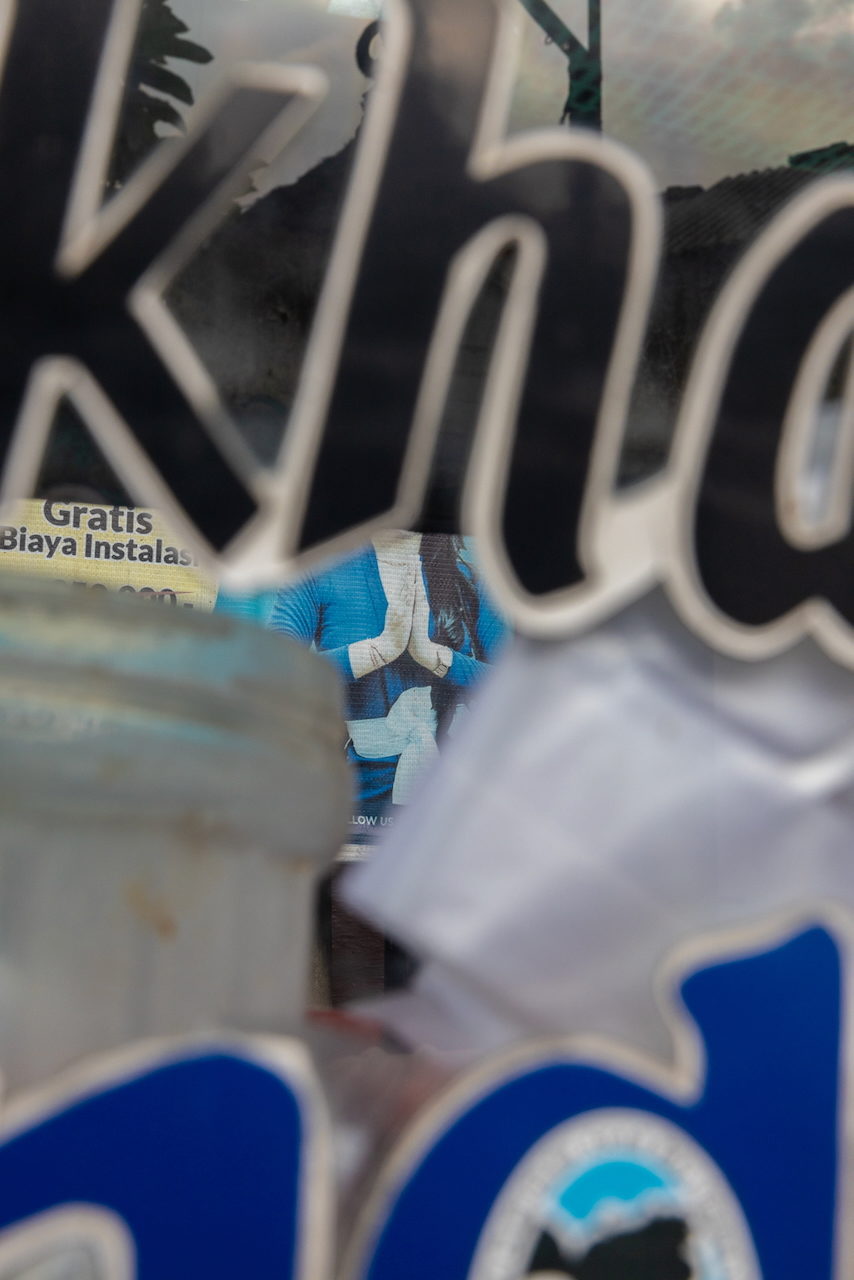 White script lettering across a blue advertising hoarding.