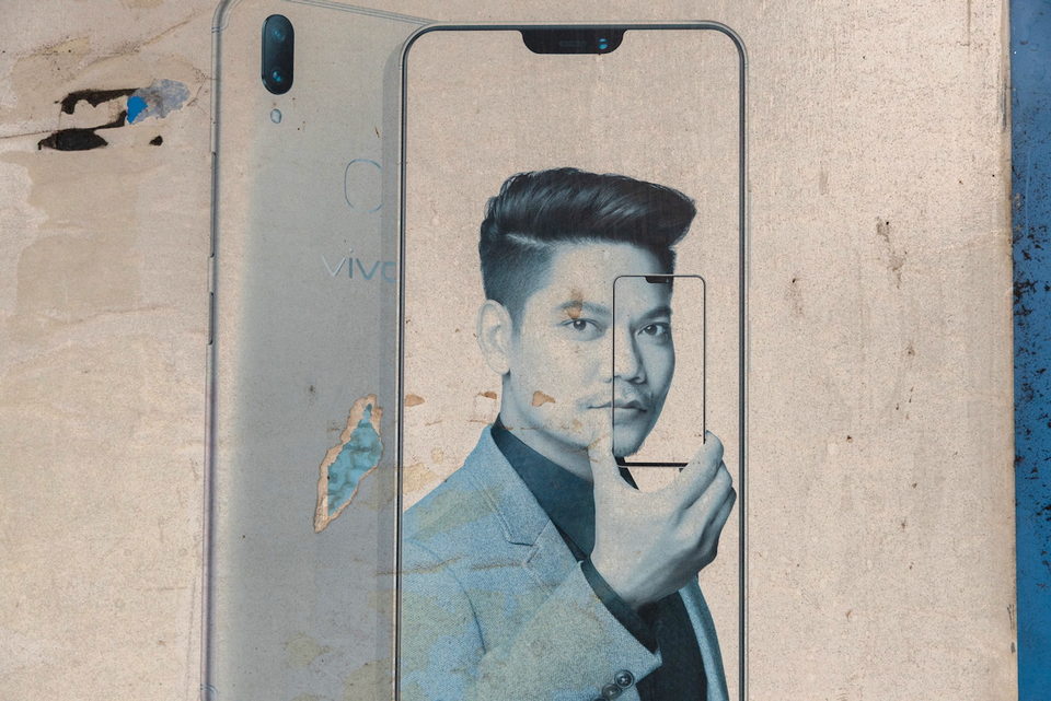 A weathered phone advertisement painted on a wall.