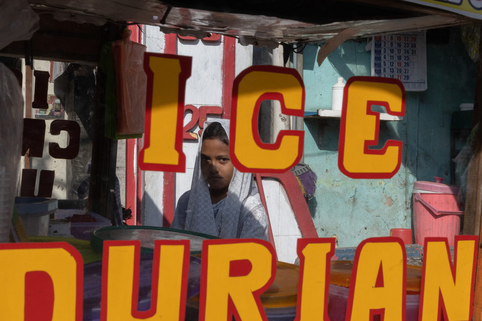 Red and yellow lettering framing a woman's face beyond the cart window.